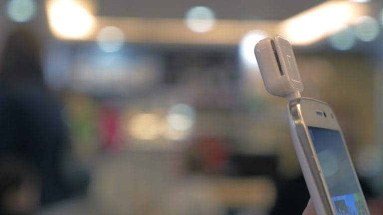 Girl using mobile terminal on phone and pays for purchase through card