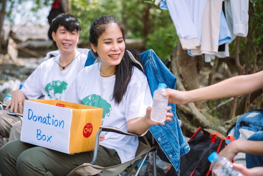 Group of asian diverse people volunteer holding a donation box for fundraiser to emergency situation